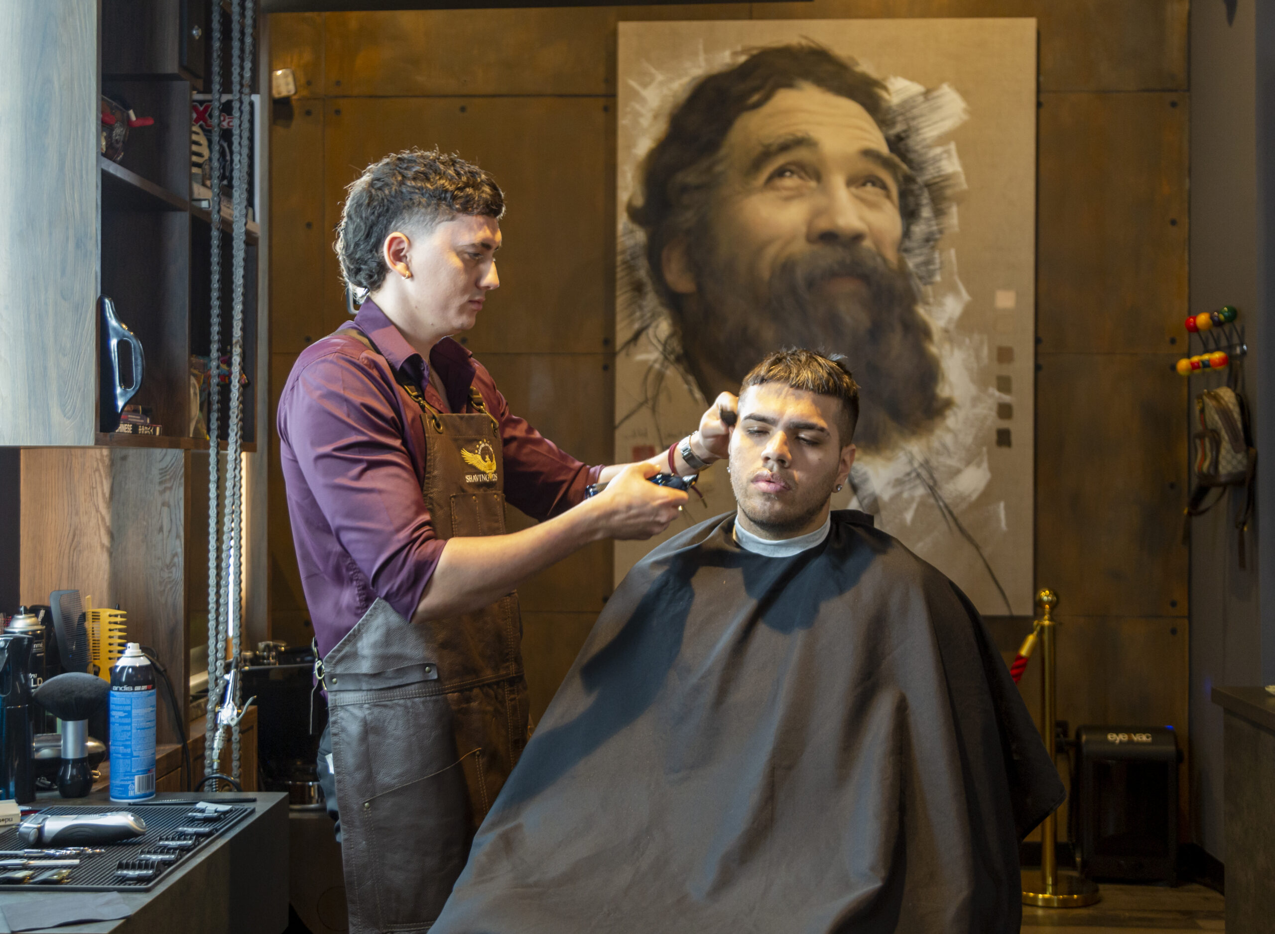 Barber at work under the portrait