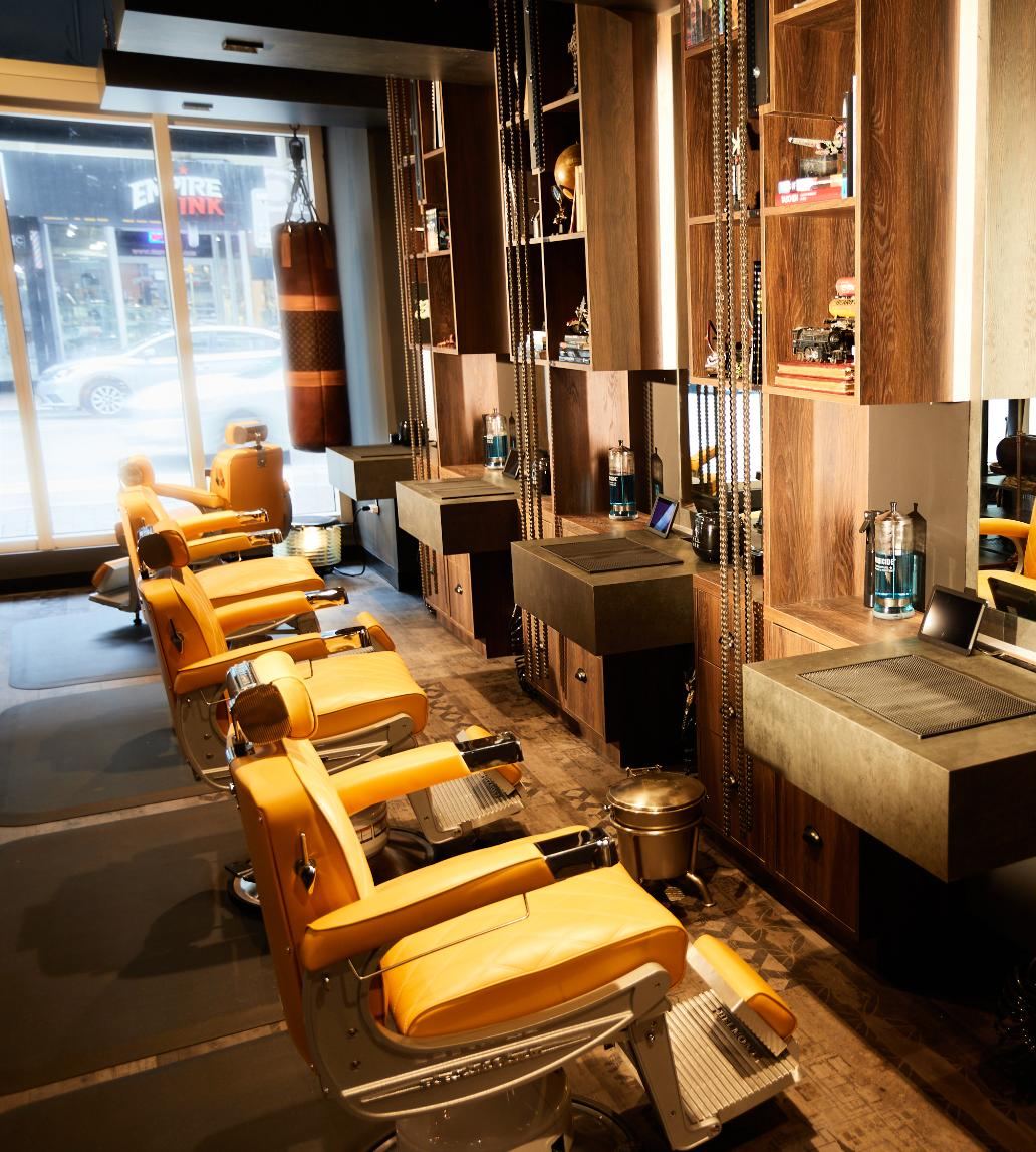Row of mustard Belmont barber chairs