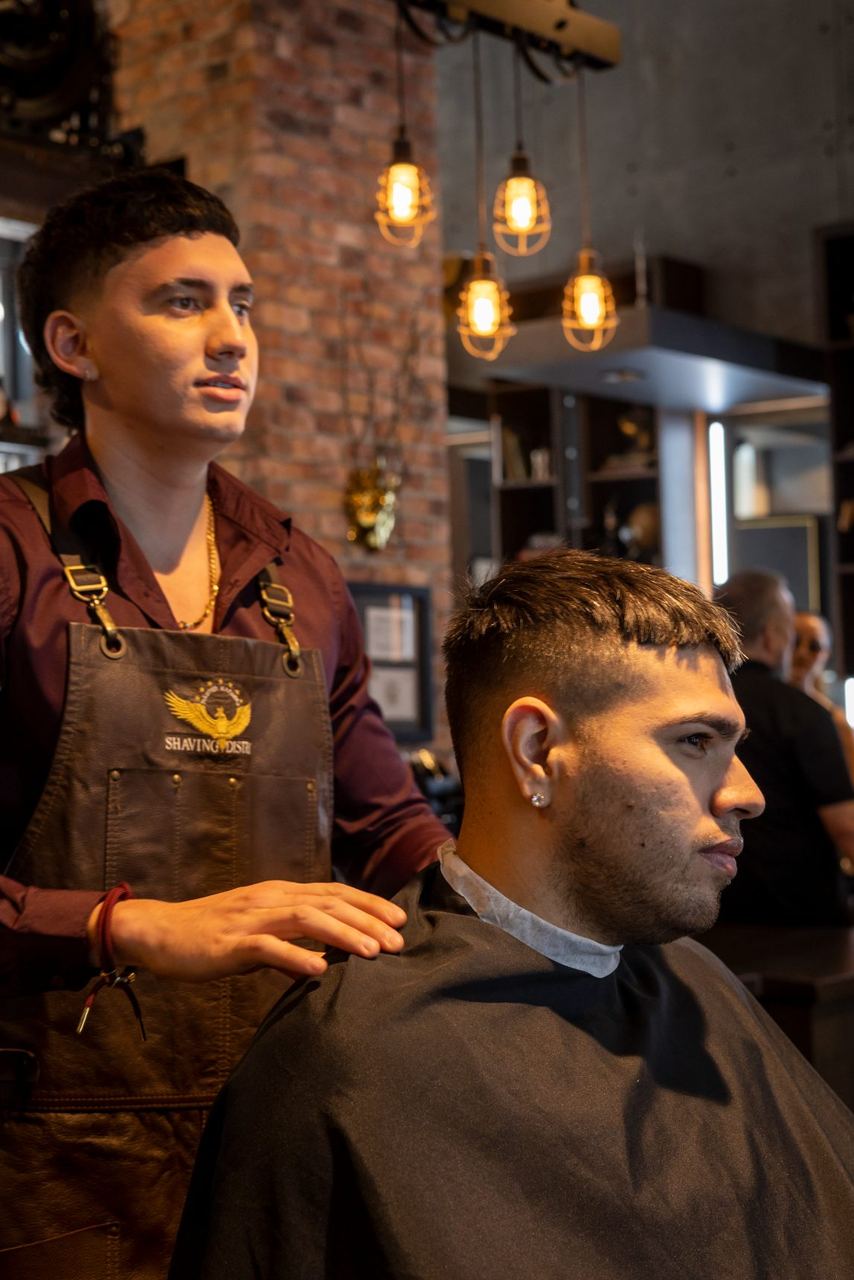 Barber finishing a haircut and beard trim